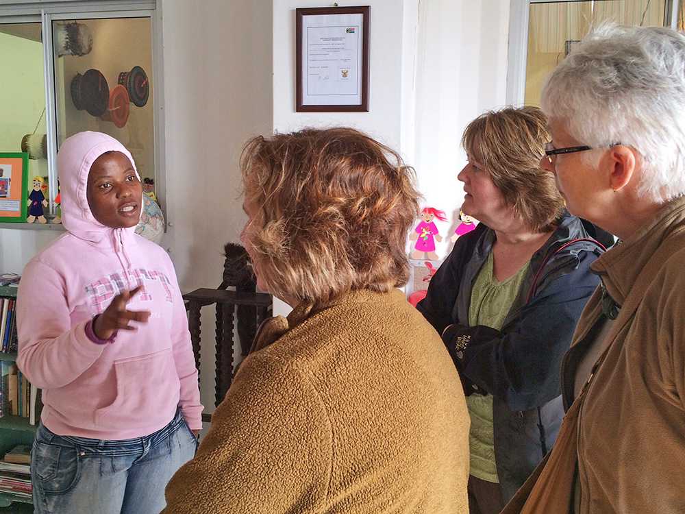 Nwabisa Ndongeni, project leader of The Heart of a Woman Project talks about the program to tourists visiting the centre on tour with Uthando South Africa, a responsible tourism organization.